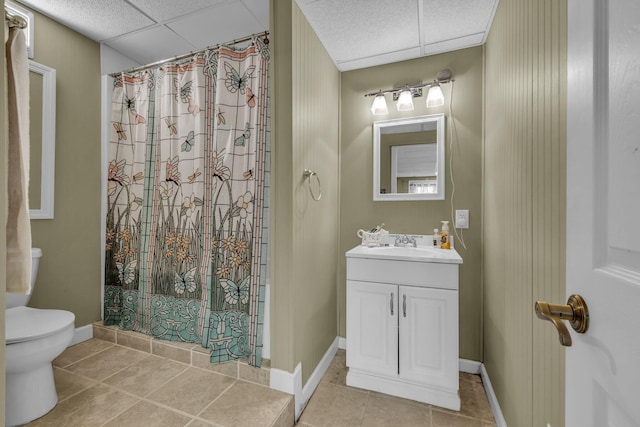 bathroom with tile patterned flooring, vanity, a drop ceiling, and a shower with shower curtain