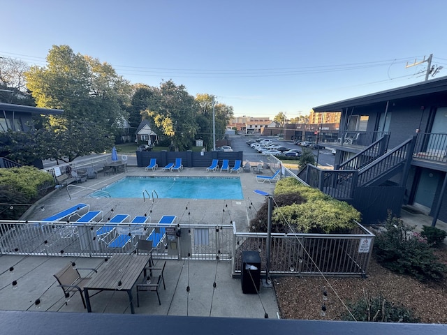 view of swimming pool with grilling area and a patio