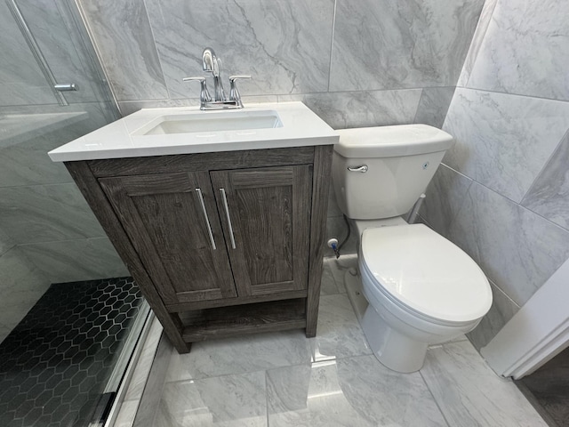 bathroom with vanity, a shower with door, and toilet