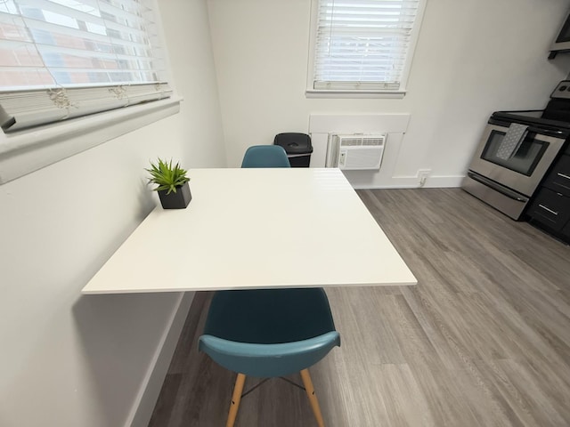 office featuring wood-type flooring and an AC wall unit