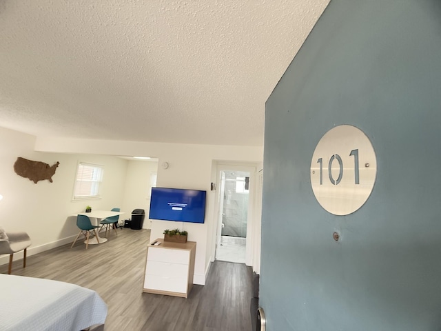 bedroom with hardwood / wood-style flooring and a textured ceiling