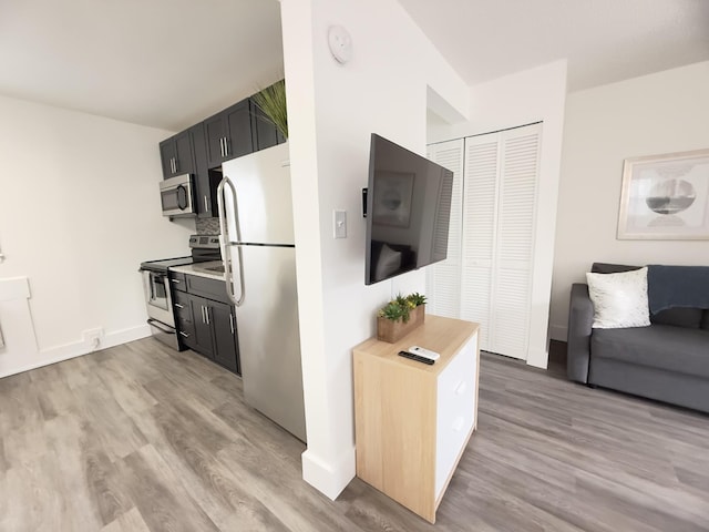 kitchen featuring stainless steel appliances and light hardwood / wood-style flooring