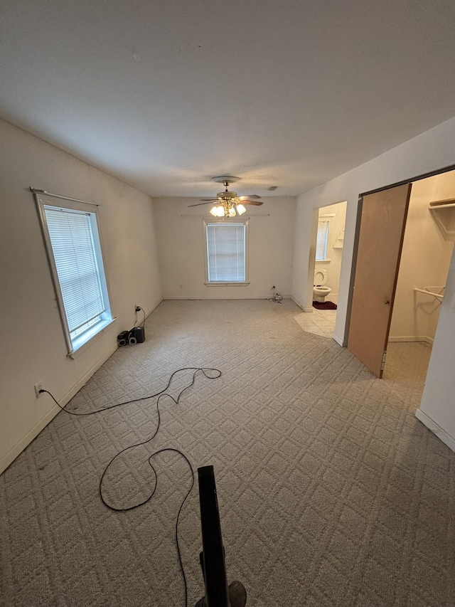 empty room featuring light carpet and ceiling fan