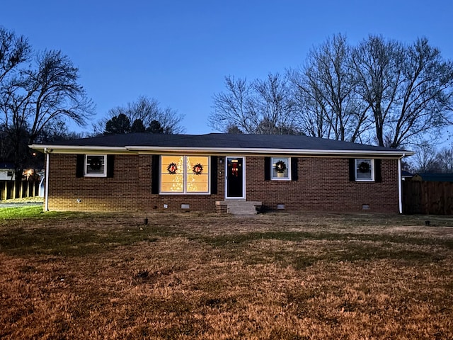 ranch-style home with a yard