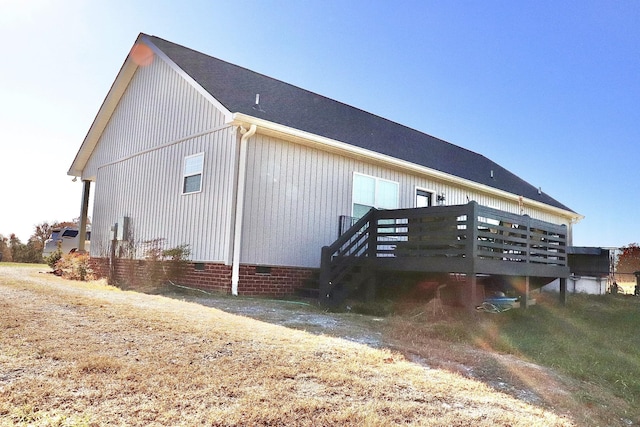 rear view of property featuring a deck