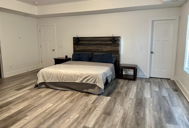 bedroom with hardwood / wood-style floors