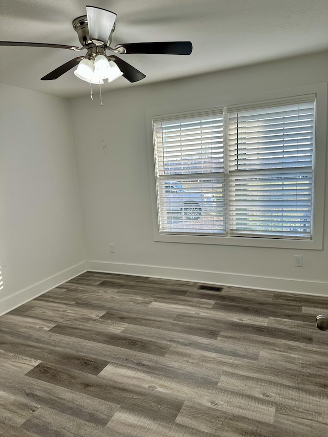 spare room featuring ceiling fan and dark hardwood / wood-style flooring