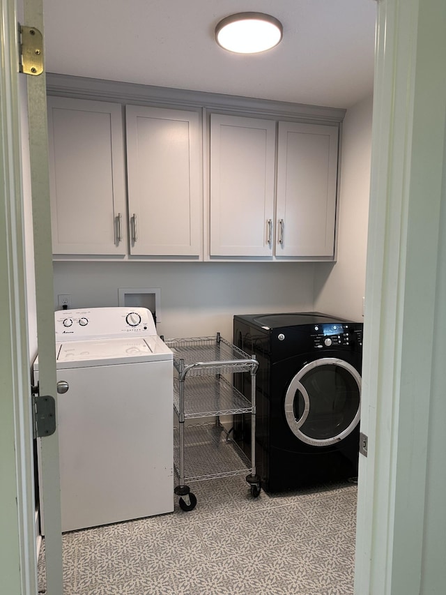 laundry room featuring cabinets and washing machine and clothes dryer