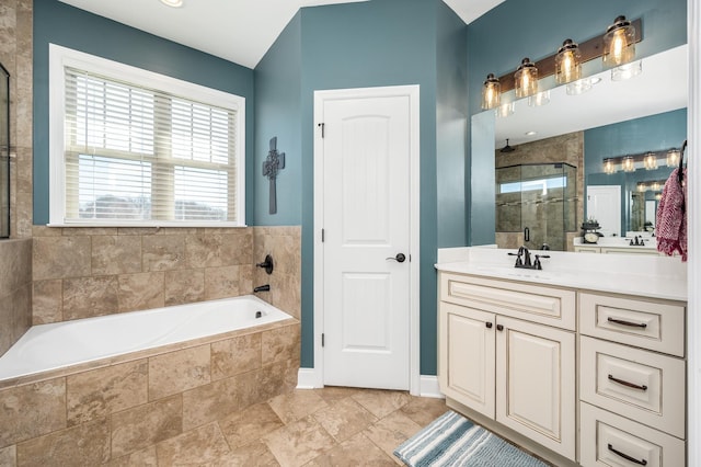 bathroom with vanity and shower with separate bathtub