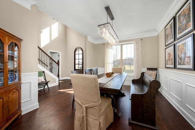 dining area with a chandelier, dark hardwood / wood-style floors, and ornamental molding