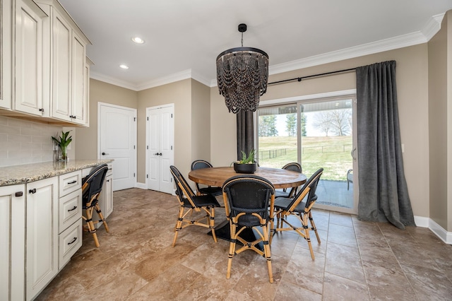 dining area with a notable chandelier and ornamental molding