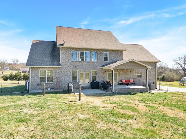 back of property featuring central air condition unit, a patio area, a yard, and french doors