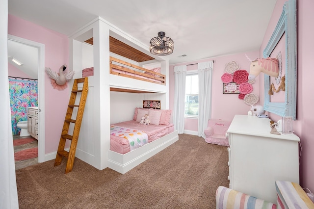 carpeted bedroom with a notable chandelier