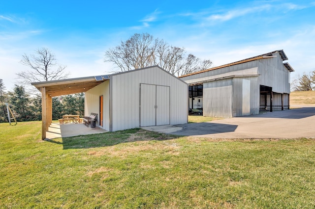 view of outbuilding with a lawn