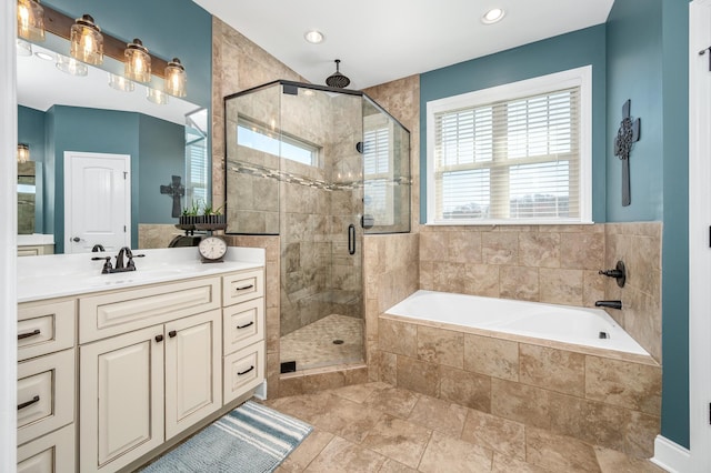 bathroom featuring separate shower and tub and vanity