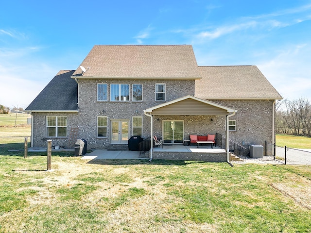 rear view of house featuring a yard, a patio, and cooling unit