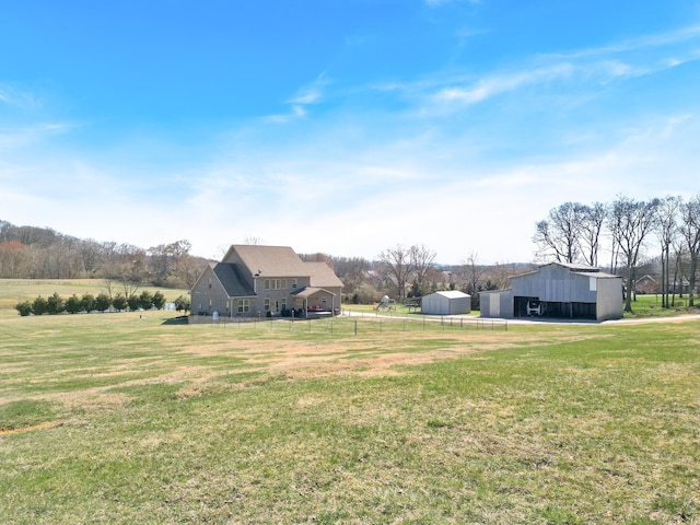 view of yard with an outbuilding and a rural view