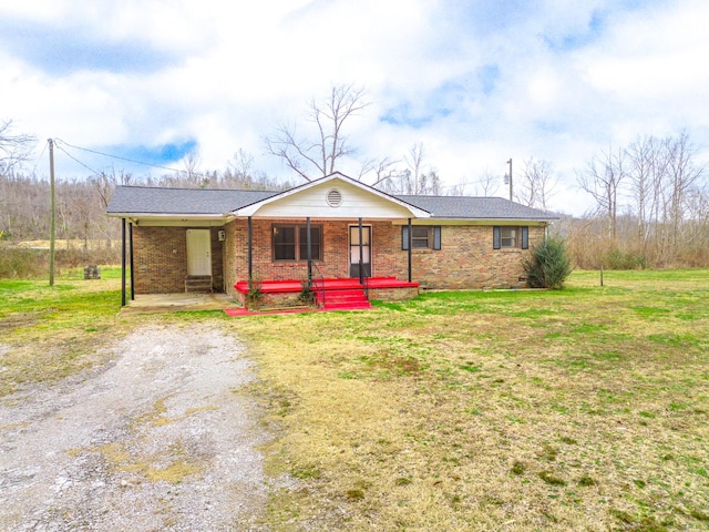 ranch-style house featuring covered porch, brick siding, driveway, crawl space, and a front yard