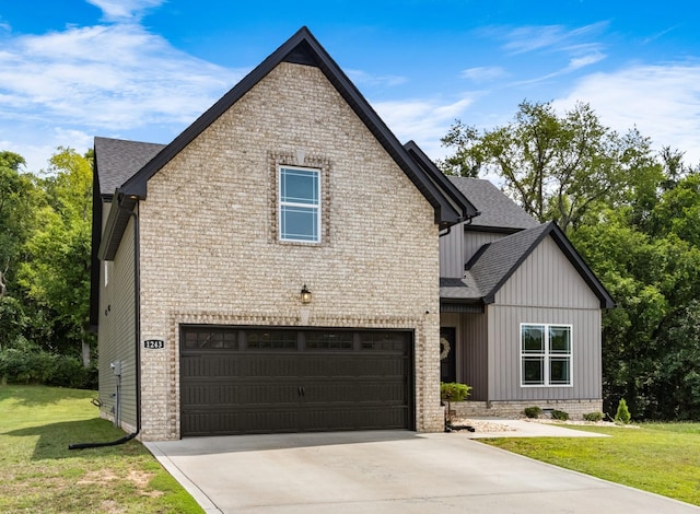 view of front of home with a front yard and a garage