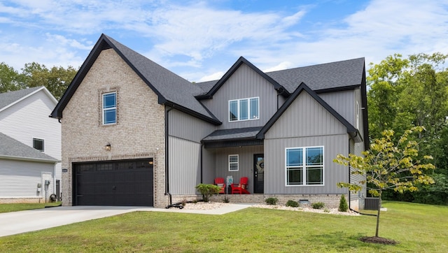 view of front facade featuring cooling unit, a garage, and a front yard