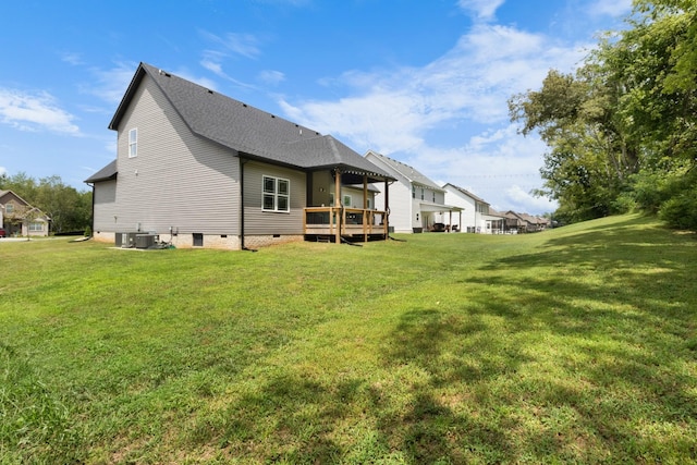 back of property with a deck, a lawn, and central air condition unit