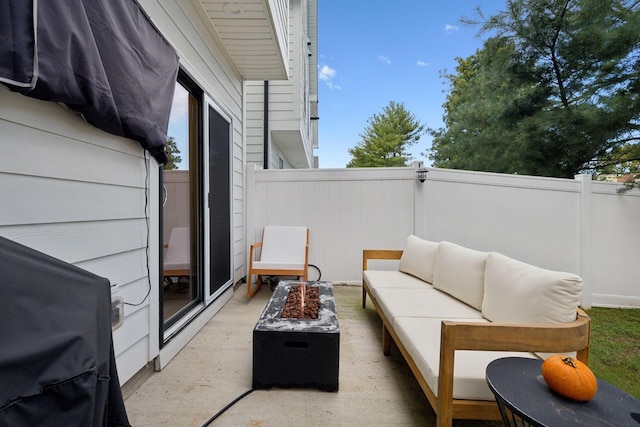 view of patio with grilling area and an outdoor living space with a fire pit