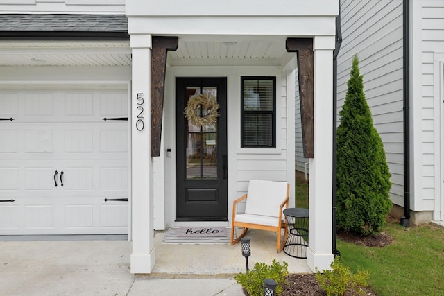 doorway to property featuring covered porch and a garage