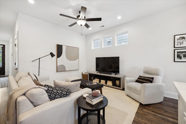 living room featuring ceiling fan and dark wood-type flooring