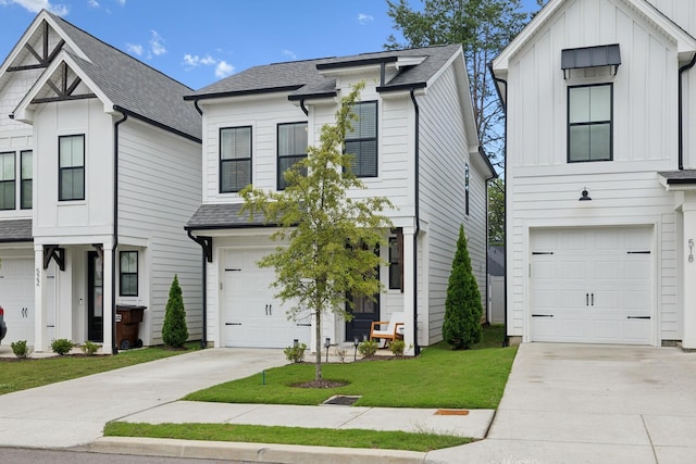 view of front of home with a front yard and a garage