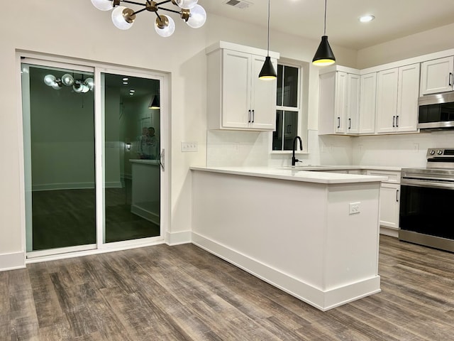 kitchen featuring white cabinets, stainless steel appliances, and a chandelier