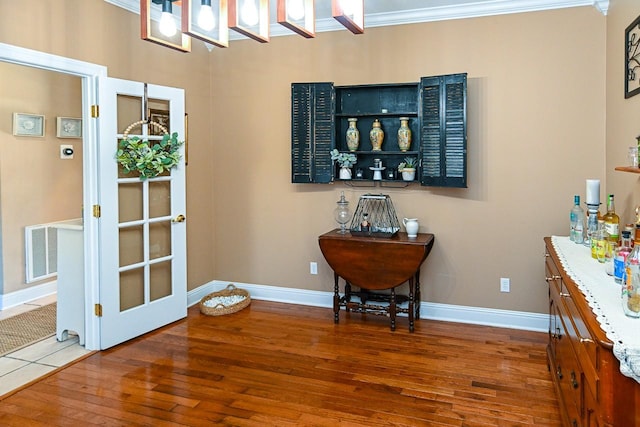 doorway featuring crown molding and wood-type flooring