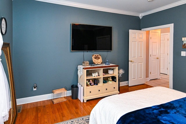 bedroom featuring crown molding and hardwood / wood-style flooring