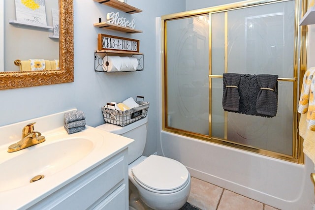 full bathroom with toilet, tile patterned floors, vanity, and bath / shower combo with glass door