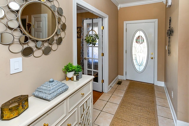 tiled foyer entrance featuring crown molding