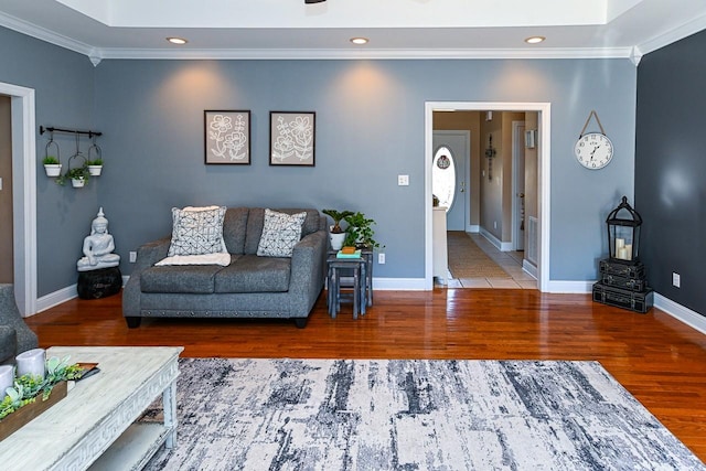 living room with hardwood / wood-style floors and crown molding