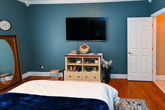 bedroom featuring hardwood / wood-style flooring and ornamental molding