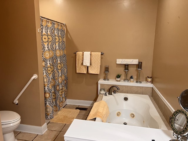 bathroom with toilet, tile patterned flooring, and tiled bath