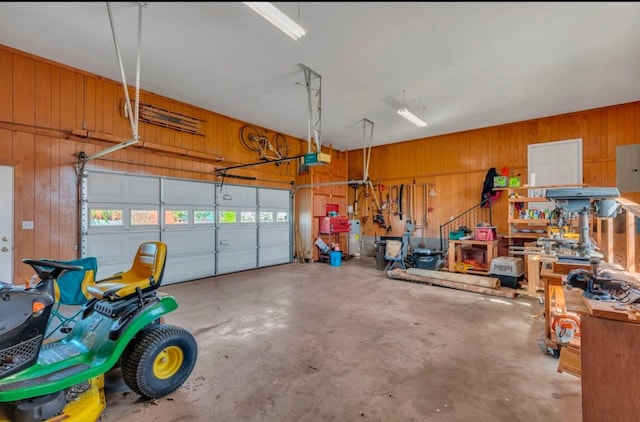 garage featuring a garage door opener and wooden walls