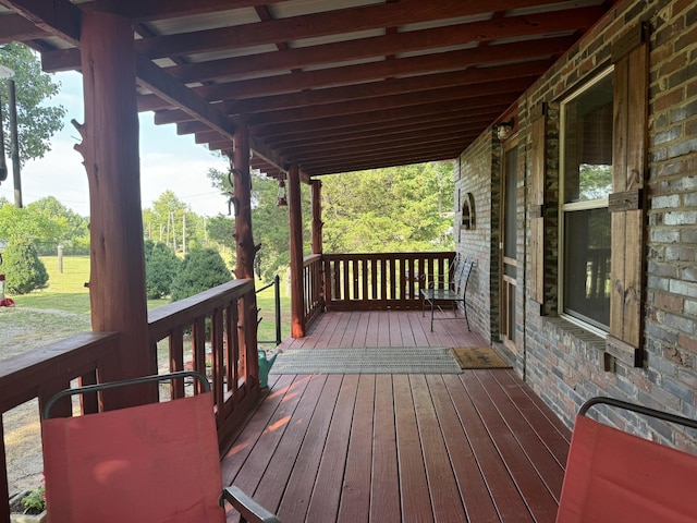 wooden terrace featuring covered porch