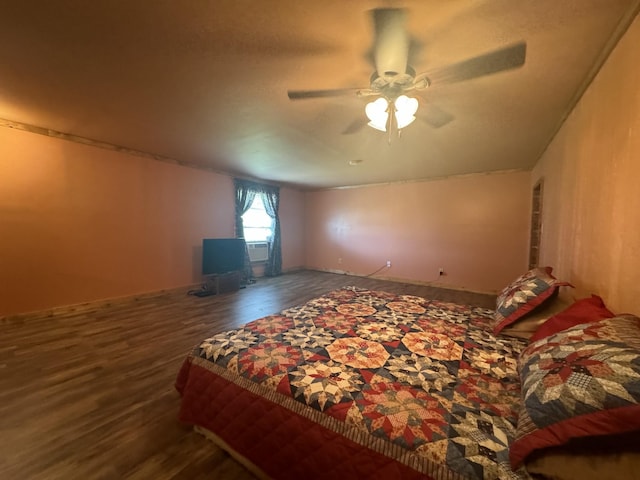 bedroom featuring ceiling fan and dark wood-type flooring