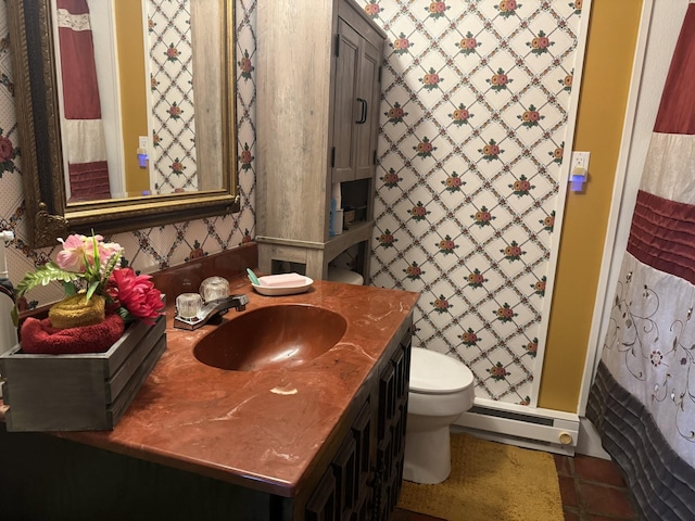 bathroom featuring vanity, a shower, tile patterned floors, toilet, and baseboard heating