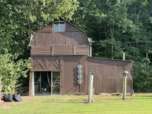 view of outbuilding with a yard