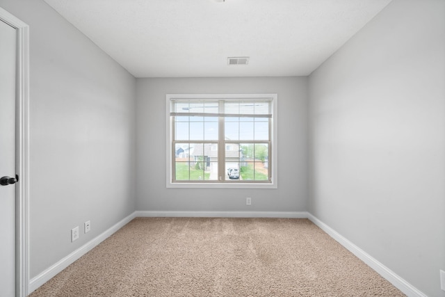 spare room featuring carpet flooring