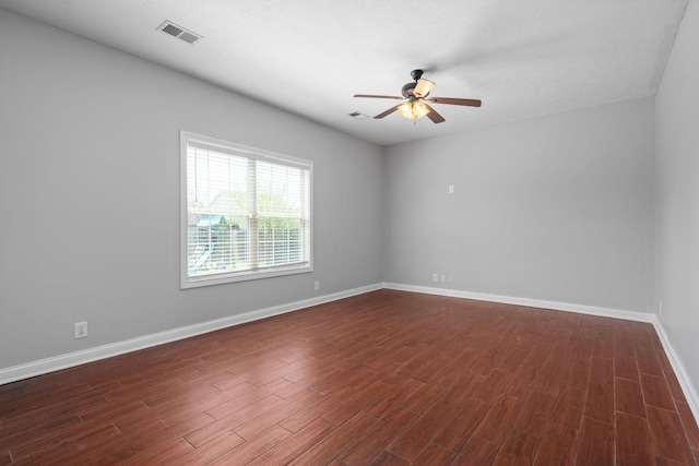 spare room featuring ceiling fan and dark hardwood / wood-style floors