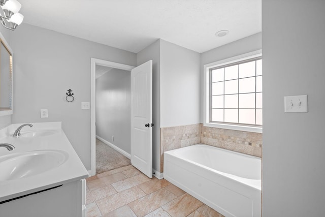 bathroom with vanity and a tub