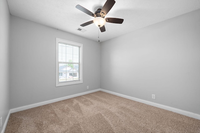 unfurnished room featuring carpet, ceiling fan, and a textured ceiling