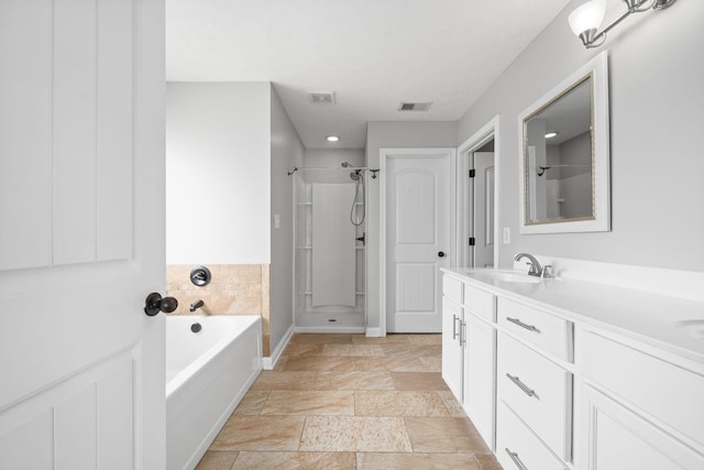 bathroom with vanity and separate shower and tub