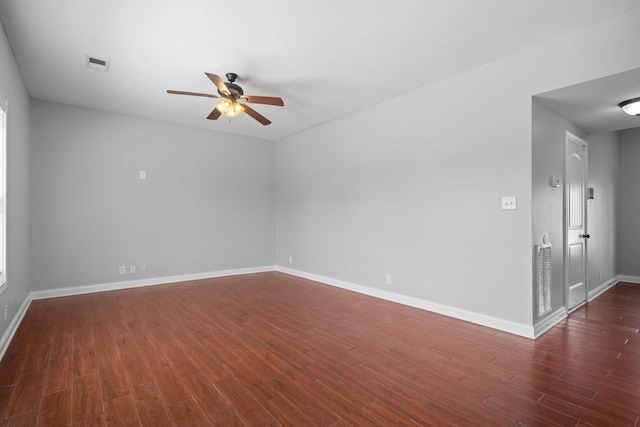 empty room with ceiling fan and dark wood-type flooring