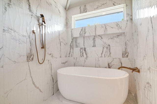 bathroom featuring tile walls and a bathing tub