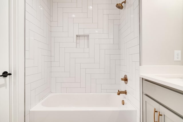 bathroom featuring vanity and tiled shower / bath